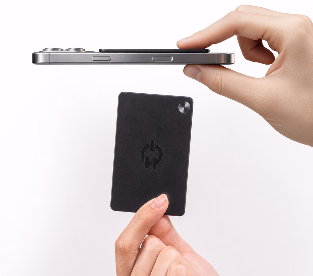 Ruune magnetically attached to a phone and held in hand, showing its slim profile